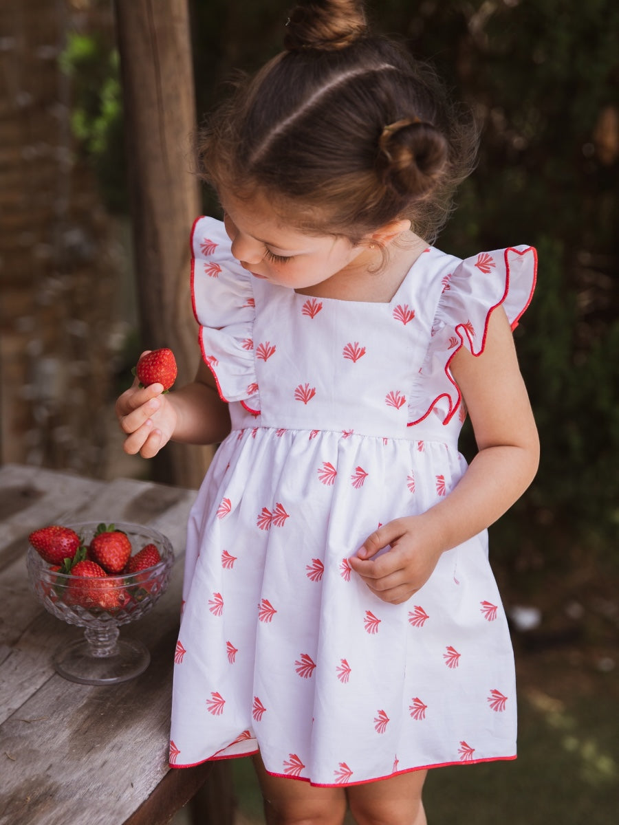 Vestido blanco con detalles rojos y lazada en espalda